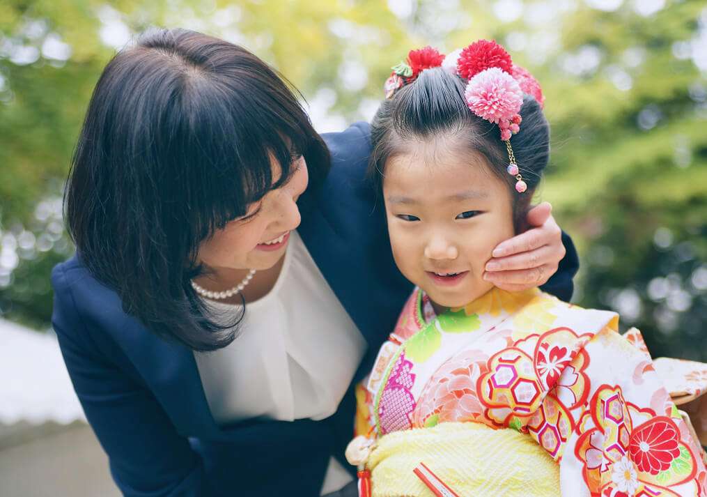 子供のほっぺに手をあてるママ