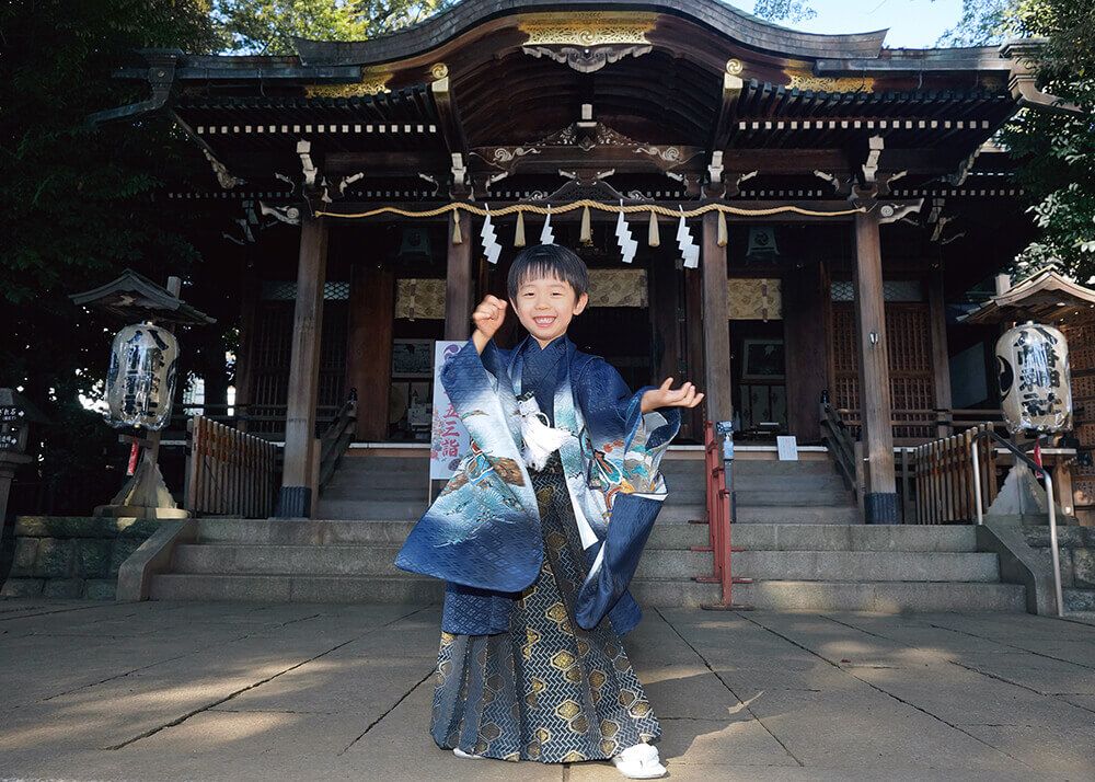 中目黒八幡神社の本殿前でポーズをとる七五三の男の子