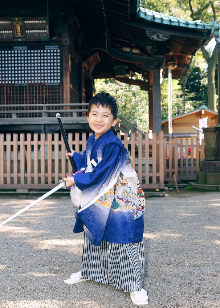 代々木八幡宮の境内で刀を持ってポーズをとる七五三の男の子