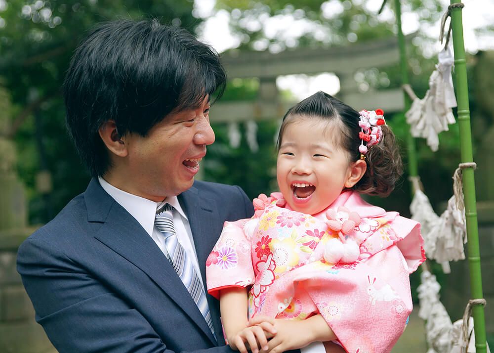 氷川台氷川神社でパパに抱っこされて喜ぶ七五三の女の子